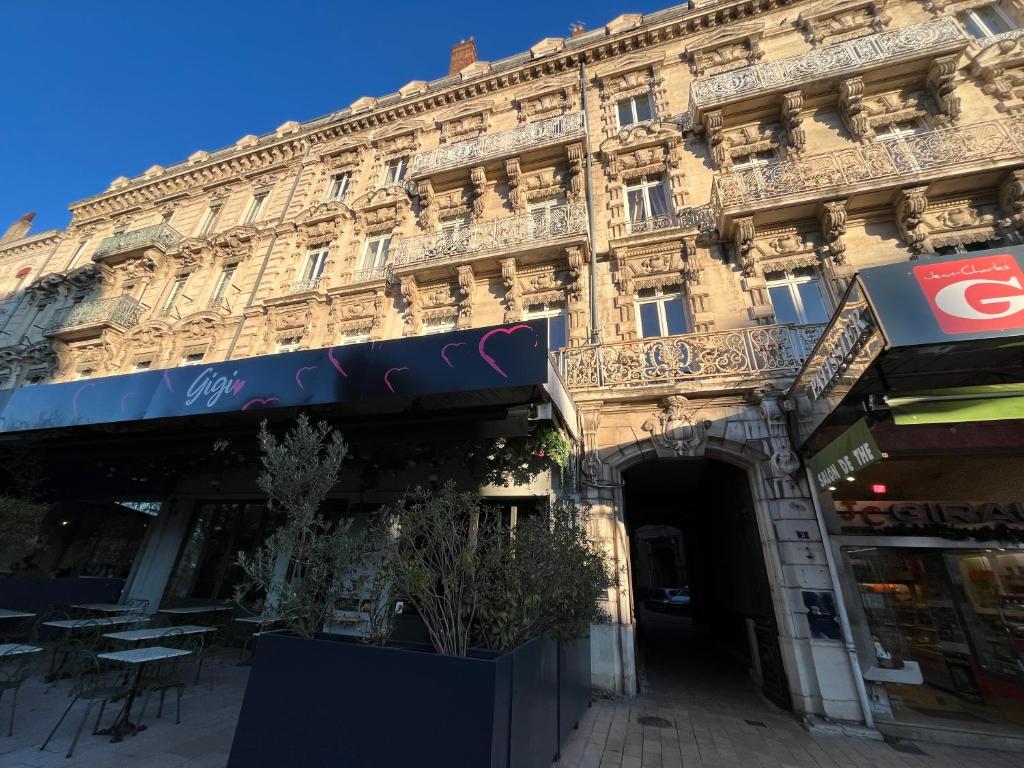a large building with a sign in front of it at Chez MARIE in Valence