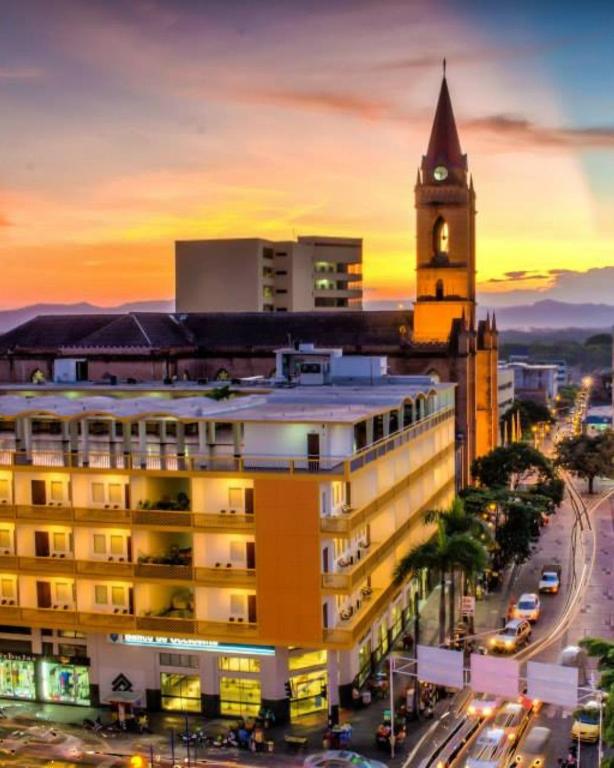 a city with a clock tower and a building at Hotel Neiva Plaza in Neiva