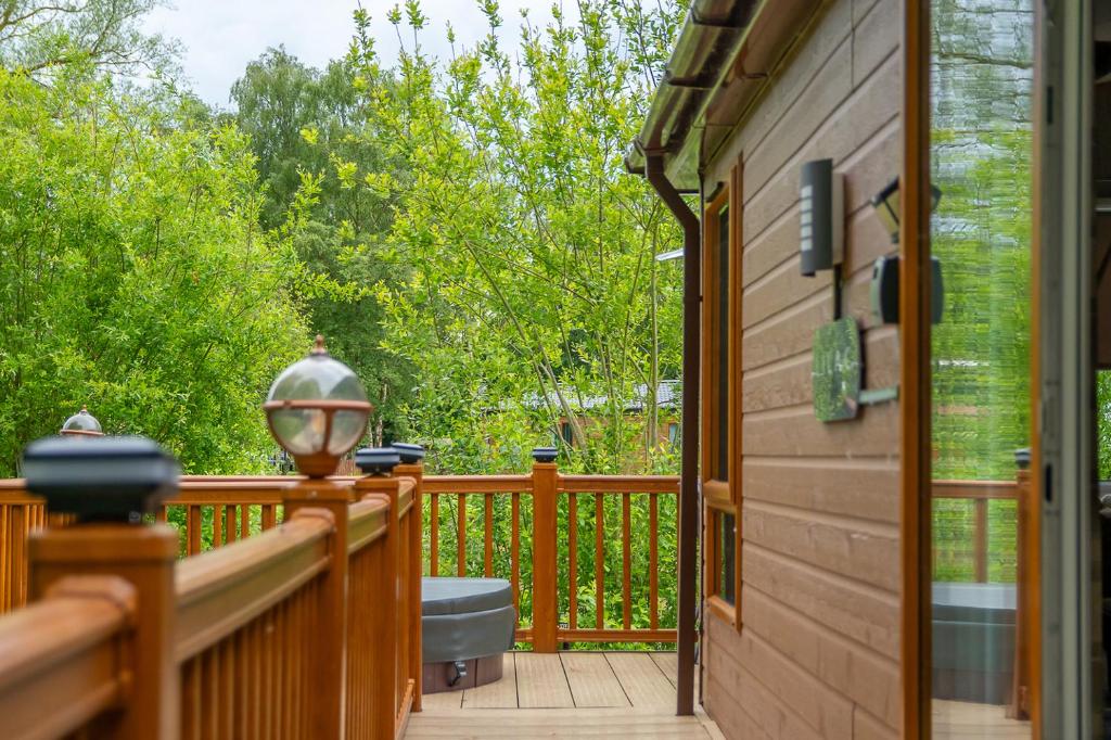 a porch of a cabin with a view of the woods at Looby Lodge in Tattershall