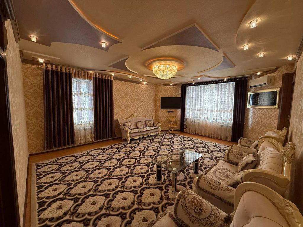 a large living room with a couch and a table at The Skyline Apartments in Samarkand