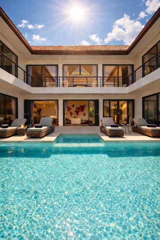 a house with a swimming pool in front of it at Villa Nomada Exclusive Modern Seaview Spa and Wellness Villa with Daily Housekeeping 5 Bedrooms Sauna Ice Bath and 20 Meter Private Saltwater Pool in Ban Bang Po