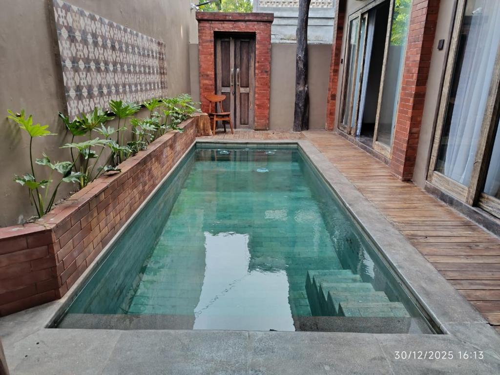 a swimming pool in the middle of a house at Jagad Villa with 3 Bedroom in Ungasan