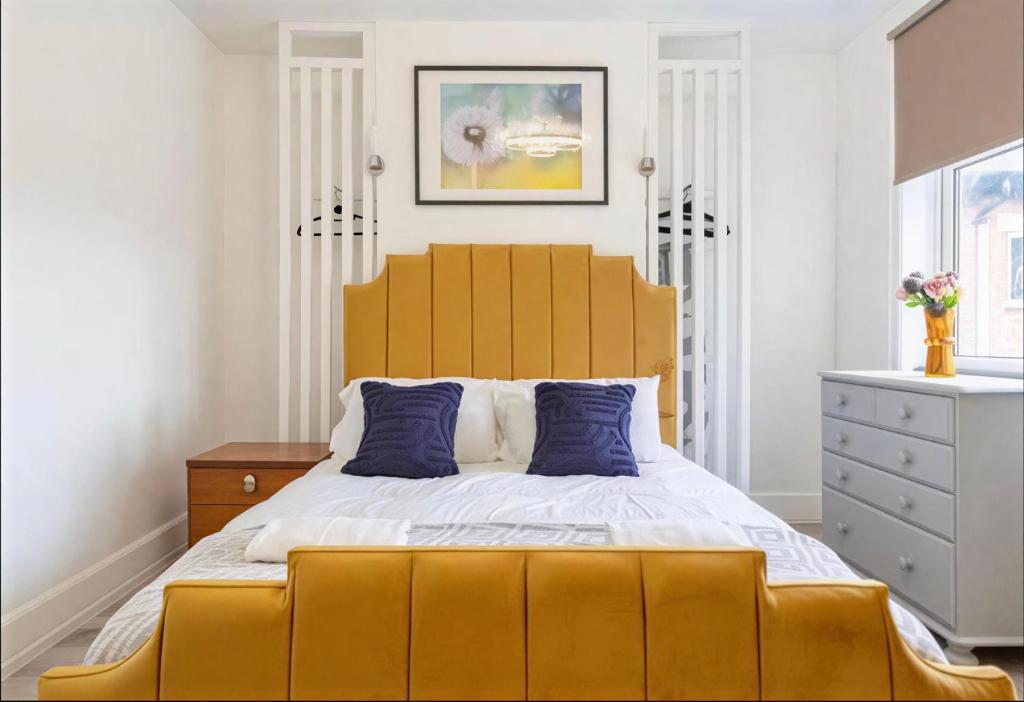 a bedroom with a large yellow bed and a dresser at Walsgrave Road 3BR Multi-Floor Apartment Unit - Free Parking & WiFi in Wyken