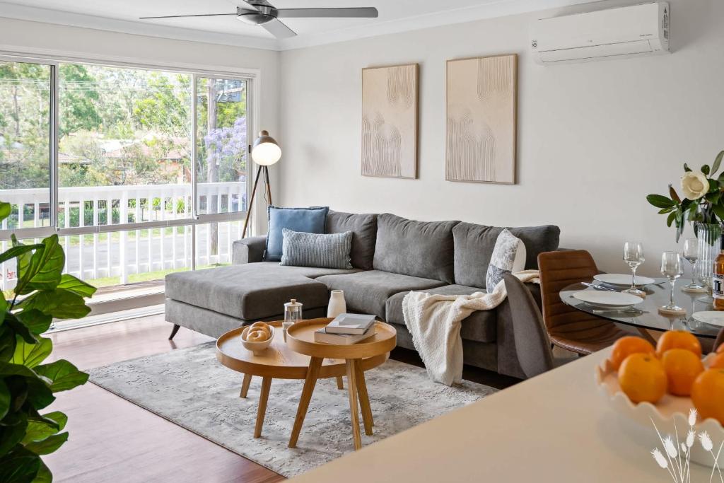 a living room with a couch and a table at Kangaroo Sanctuary in Sanctuary Point