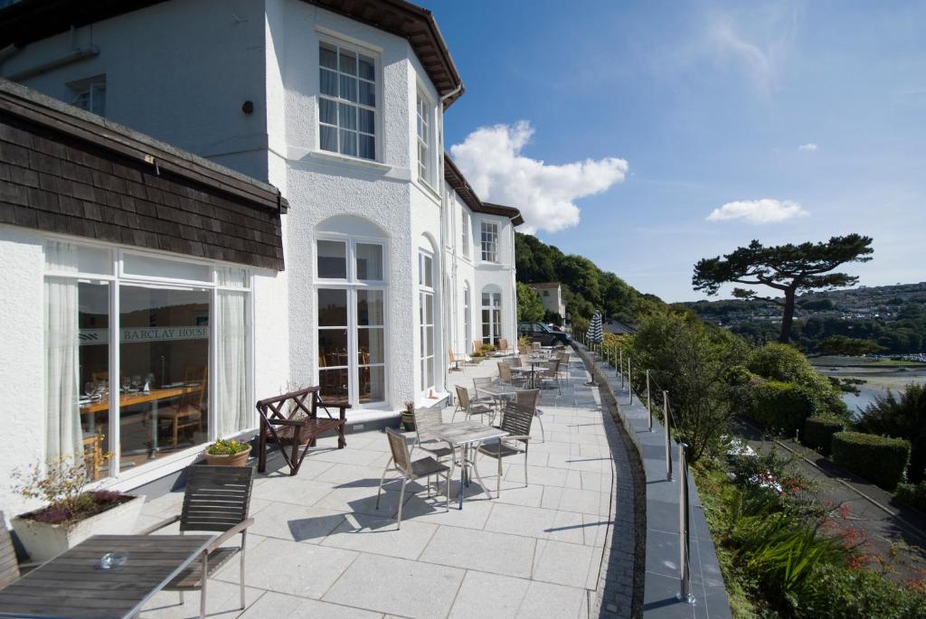 a stone building with a view of the ocean at Commonwood Manor in East Looe