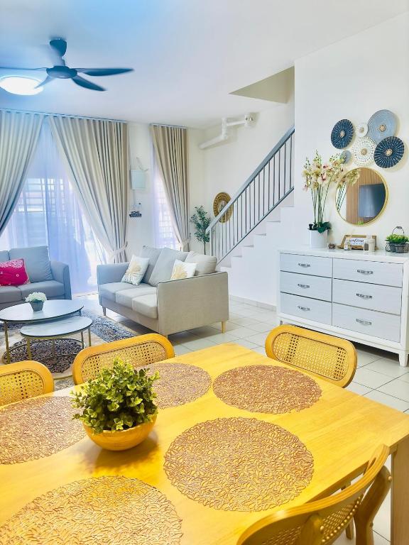 a living room with a wooden table and chairs at Voila PD Homestay in Lukut