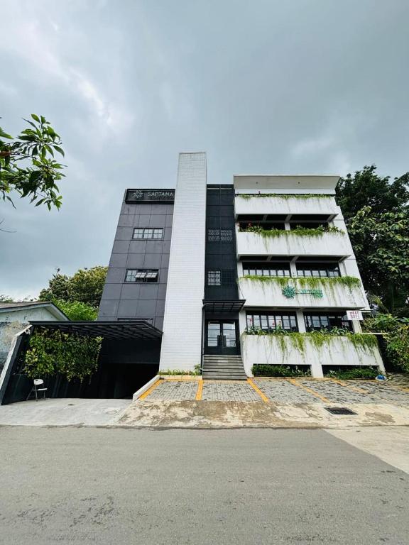 a tall building with a staircase in front of it at Saptama Living in Citaringgul 1
