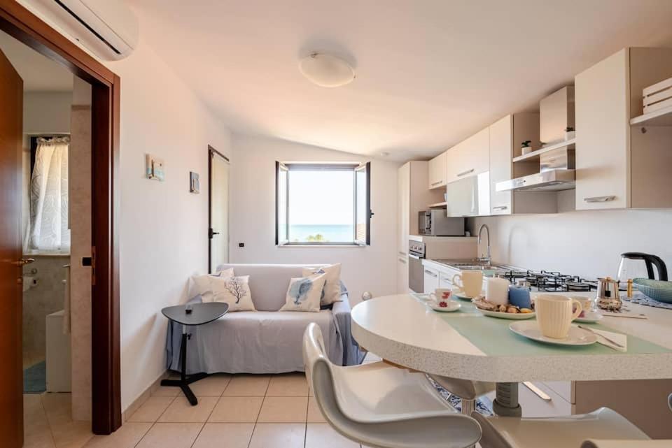 a kitchen and living room with a couch and a table at Lovely Flat with See View in Roseto degli Abruzzi