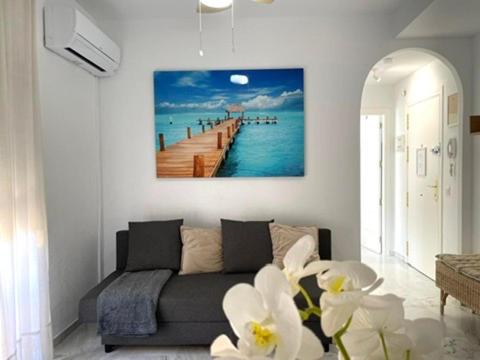 a living room with a couch and a pier at Beach Side Heaven in Fuengirola