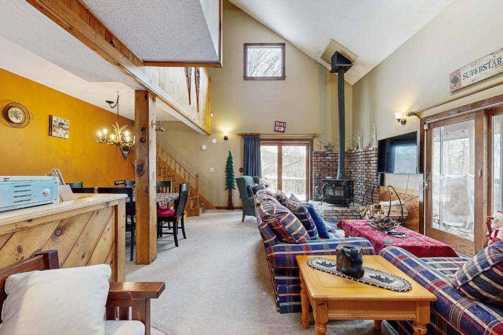 a living room with a couch and a table at Snowy Day Chalet in Killington