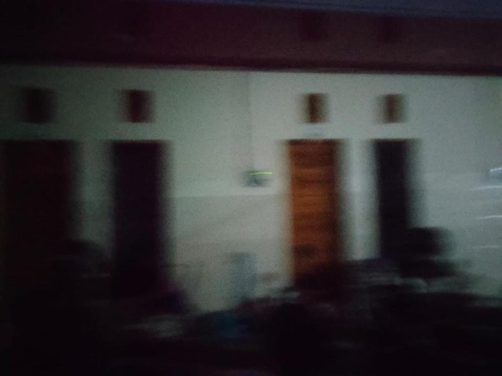 a blurry picture of a building with three windows at Udayana Bisma in Singaraja