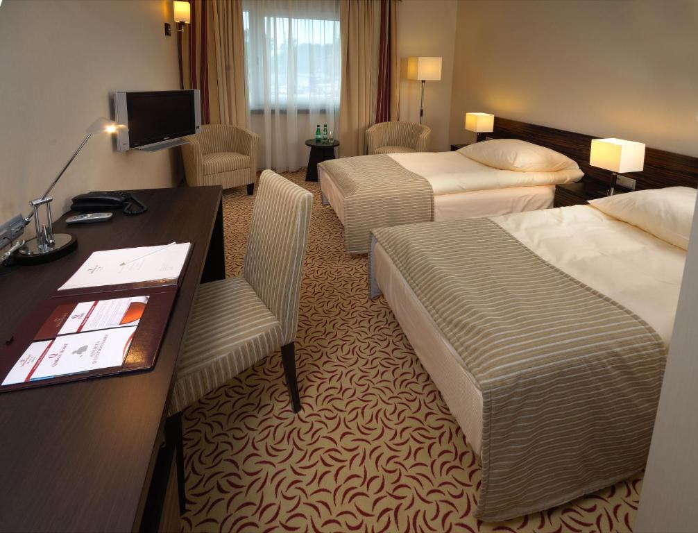 Postel nebo postele na pokoji v ubytování Qubus Hotel Kielce