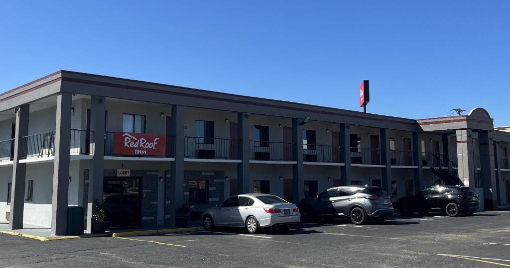 a building with cars parked in a parking lot at Red Roof Inn Kimball, TN I-24 in Kimball