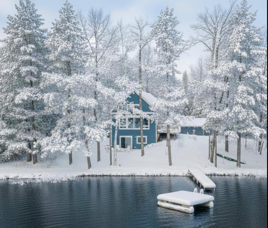 a lake with a house and a dock in the snow at Driftwood Cabin Near Eagle River, WI in Saint Germain