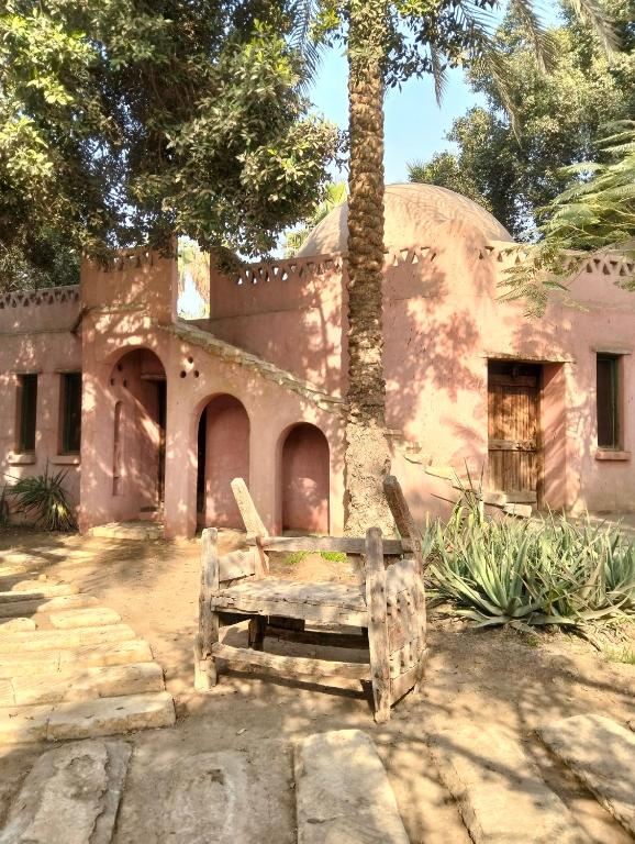 a bench sitting in front of a house at Chalet besides sakkara piramid in Cairo