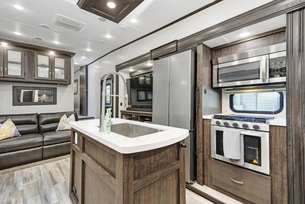 an rv kitchen with a sink and a couch at Roam sweet roam in Ellenton