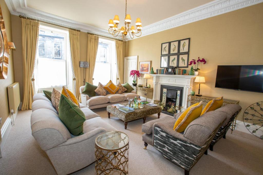 a living room with couches and a fireplace at 7 Howard Place in St. Andrews