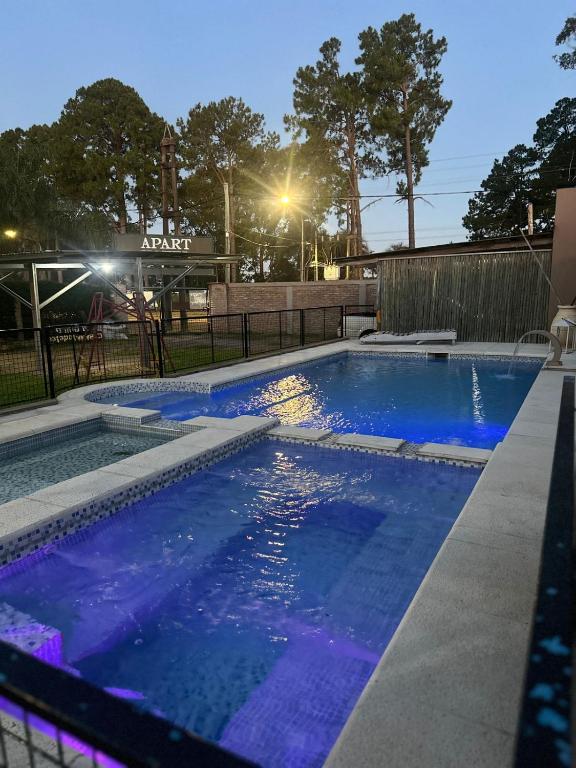 a swimming pool with blue water at night at lo de Leo in Concordia