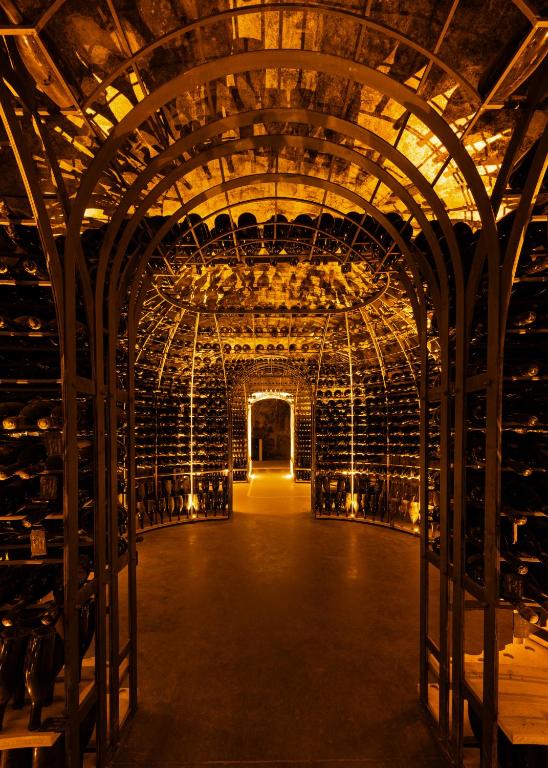 an empty wine cellar with a bunch of wine bottles at Boutique-Hôtel Le N3 par Champagne Thiénot in Reims