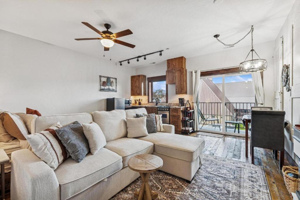 a living room with a couch and a ceiling fan at Bliss Retreat in Whitefish