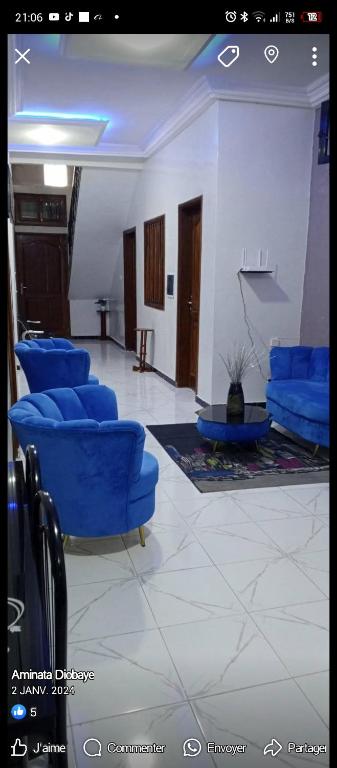 a waiting room with blue chairs in a building at Residence Maachaalah in Saint-Louis