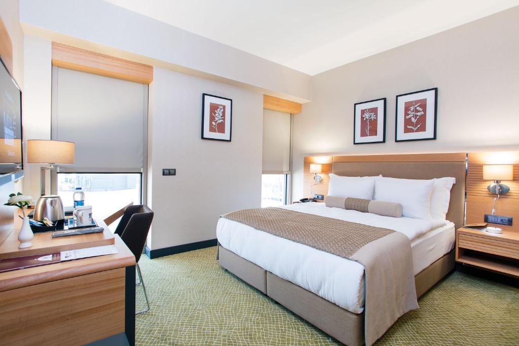 Postel nebo postele na pokoji v ubytování Mia City Hotel