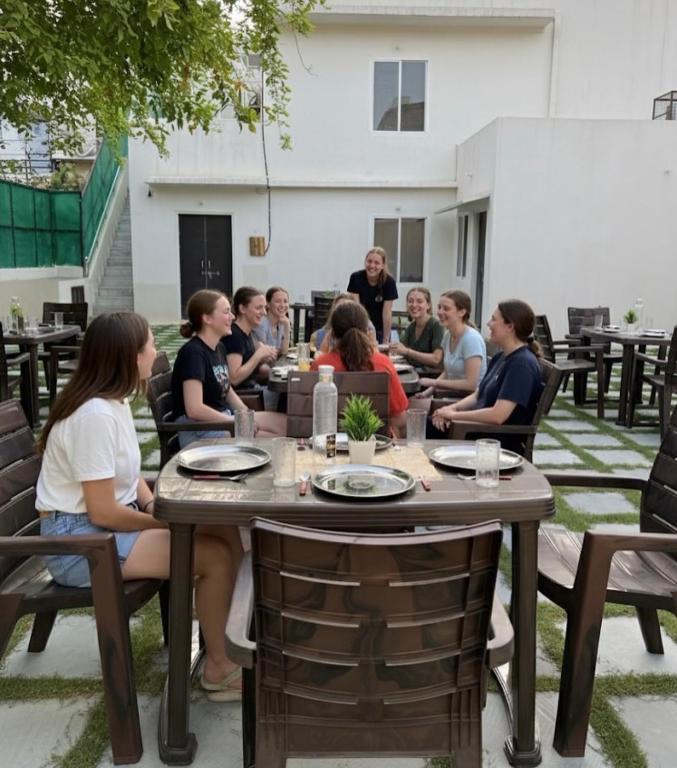 a group of people sitting around a table at Hostel ivory in Jaipur