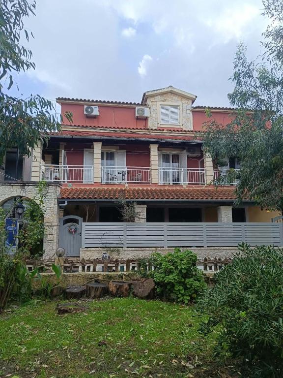 an old house with a fence in front of it at Zoe House in Sidari