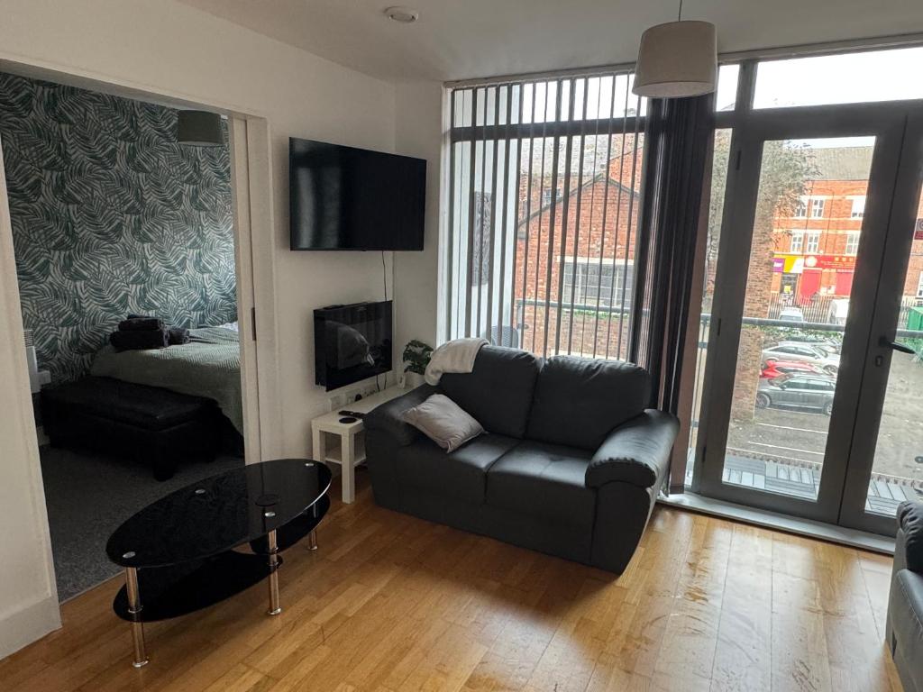 a living room with a couch and a bed at 2 Bedroom Apartment - Henry St Central Liverpool in Liverpool