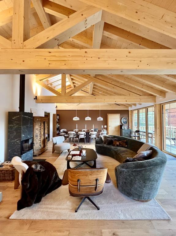 a large living room with couches and a table at La Tzoumaz Lodge in La Tzoumaz
