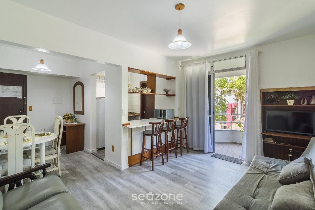 a living room and kitchen with a table and chairs at 1-Bedroom Apt in Blumenau SPN0102 in Blumenau