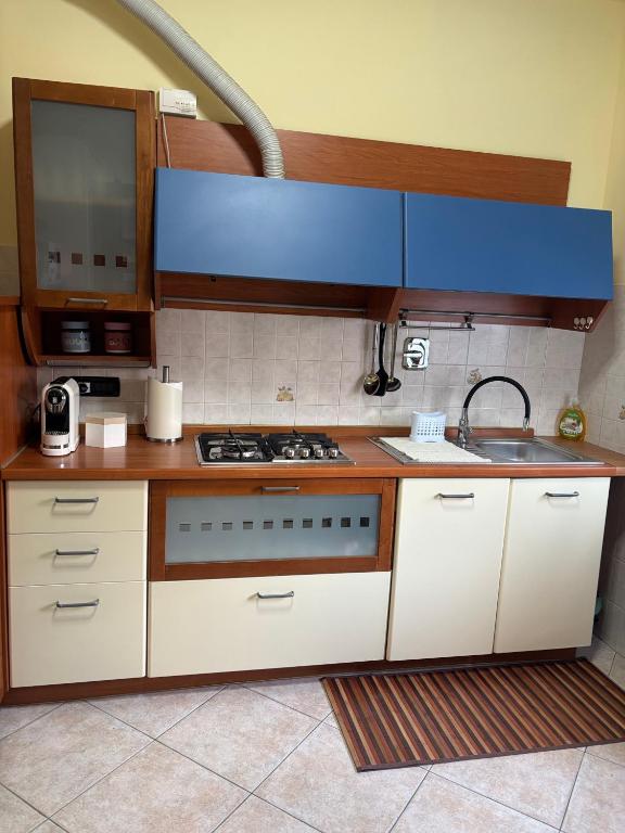 a kitchen with a stove and a sink at Casa Debby in Serravalle Scrivia