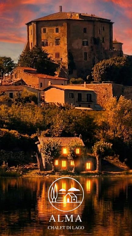 a house on a hill with a castle in the background at Alma Capodimonte Lake chalet in Capodimonte