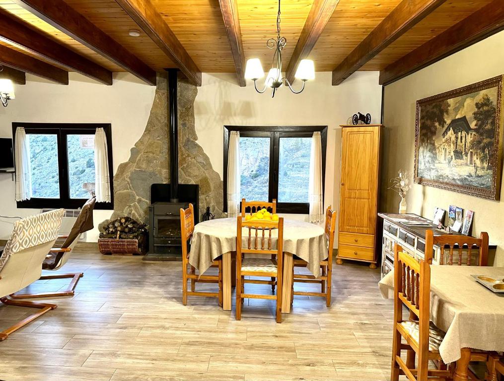 a dining room with a table and a fireplace at Casa Enry in Alcalá de la Selva