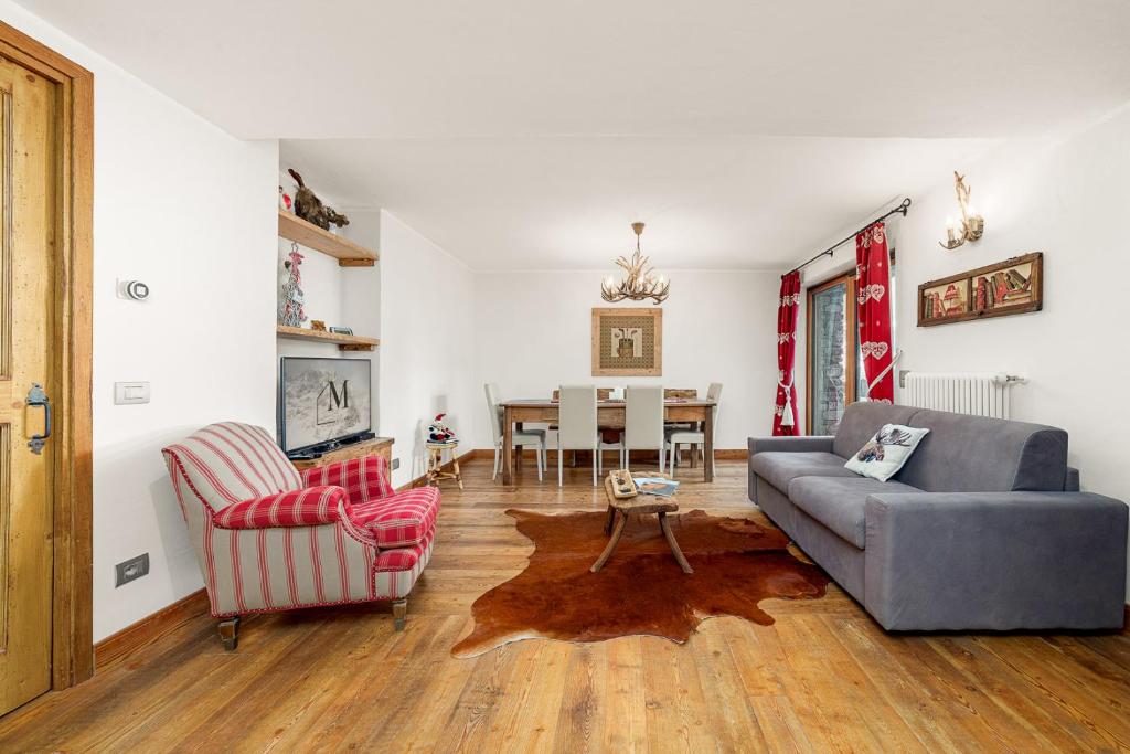 a living room with a couch and chairs and a table at Maison Carrel Elegant 1 in Breuil-Cervinia