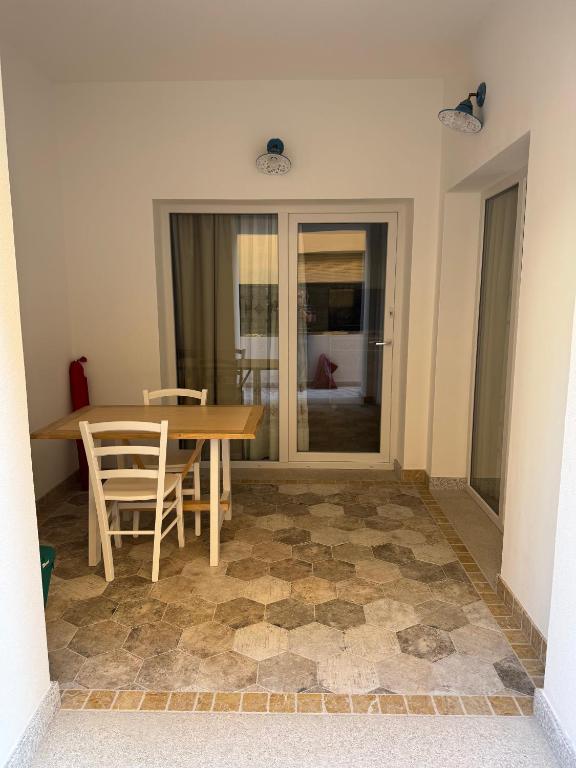 a dining room with a wooden table and chairs at Casa Gallo in Cala Gonone