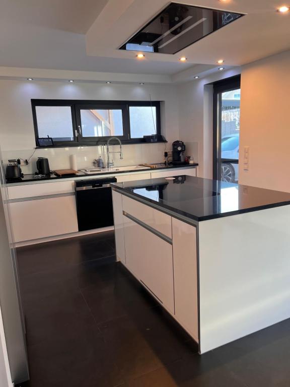 a kitchen with a black and white counter top at Villa Belmonte in Weilheim an der Teck