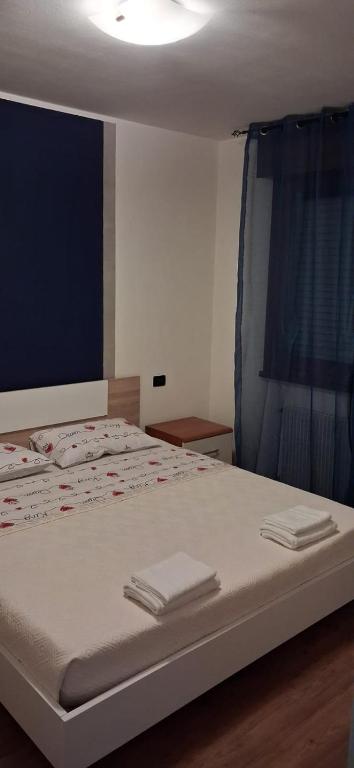 a bedroom with a bed with two towels on it at Chiara Apartment in Cervignano with 2 Double Beds in Cervignano del Friuli