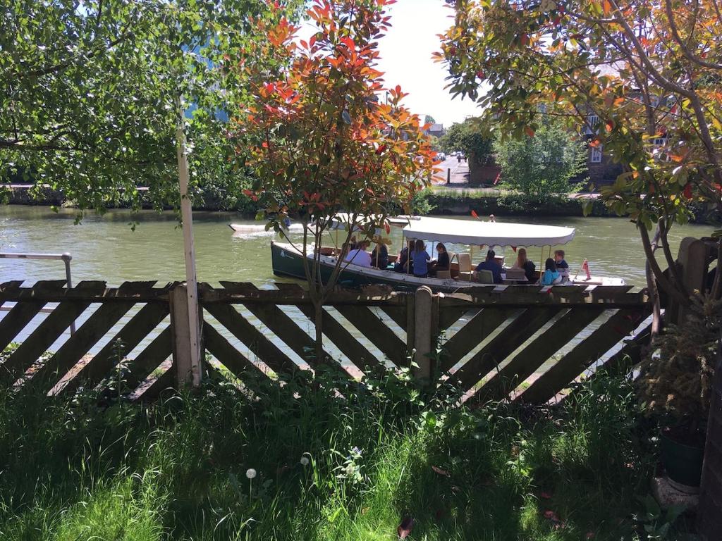a group of people in a boat on the water at The River Flat in Oxford
