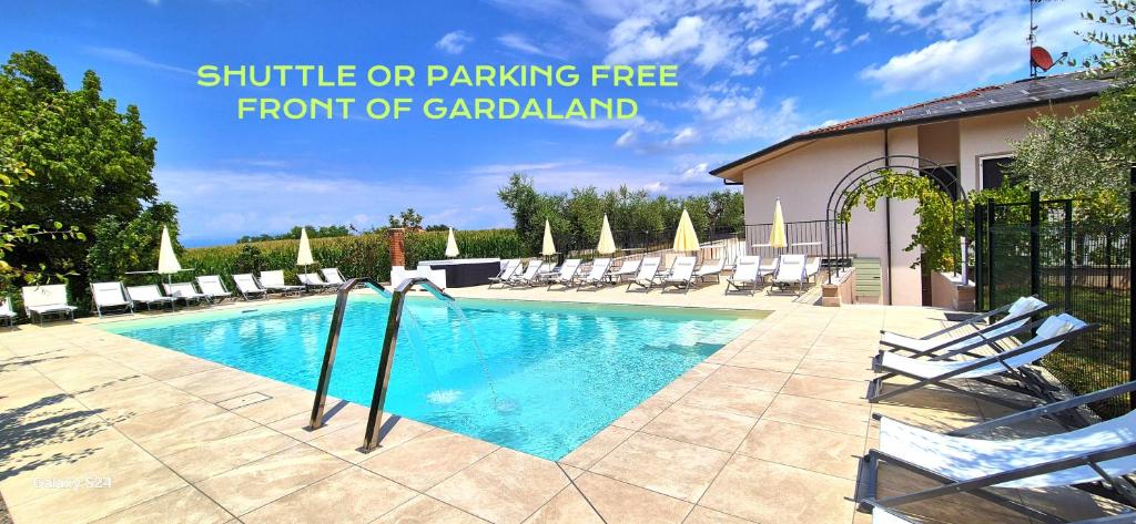 a large swimming pool with chairs in a resort at Gardaworld Oasis in Castelnuovo del Garda