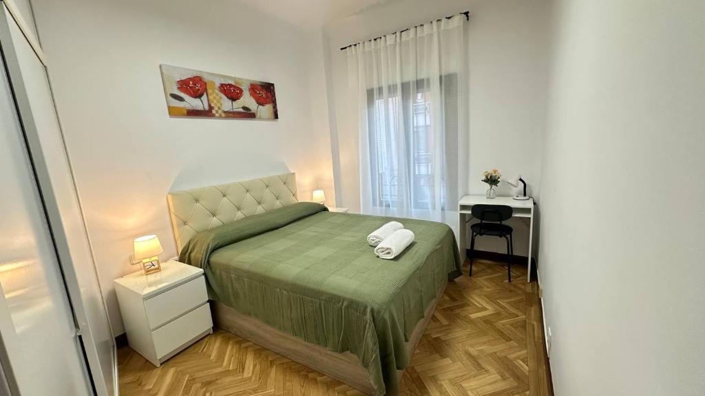 a small bedroom with a bed and a window at Habitaciones en Don Ramon in Madrid