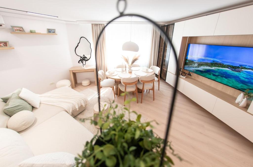 a living room with a white couch and a tv at Wabi Sabi Nest in Timişoara