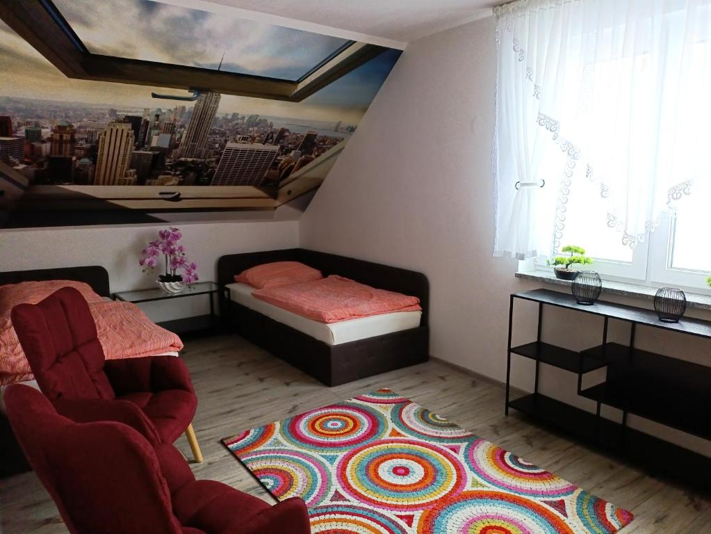 a small room with a bed and a chair and a rug at Modern Doppelhaus in Baunatal