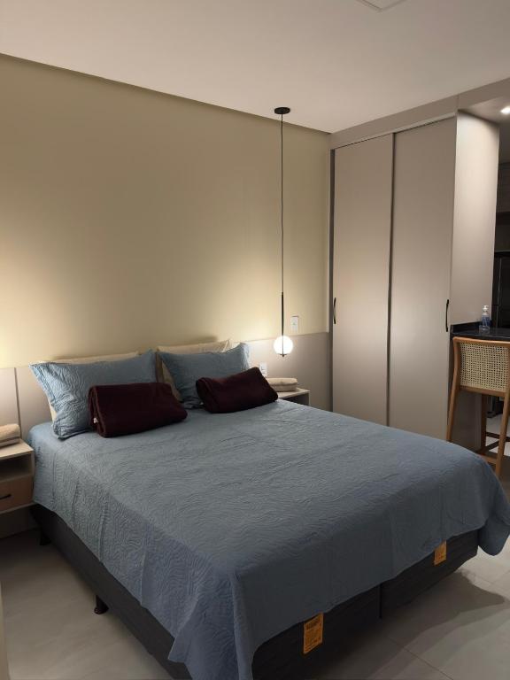 a bedroom with a large bed with two pillows at Flat em Alter do Chão in Alter do Chao