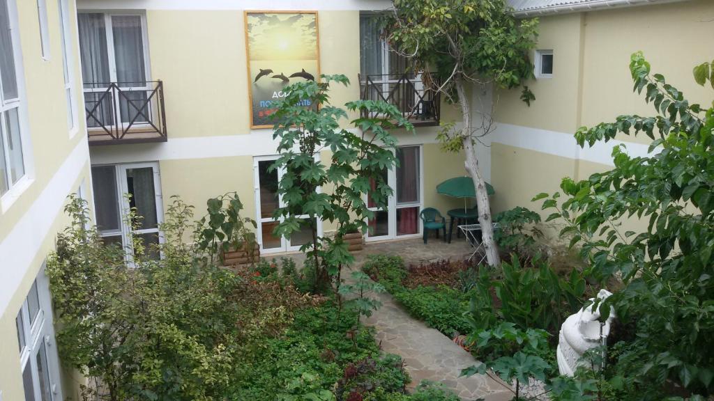 an external view of a building with a garden at Rusalka Guest House in Feodosia