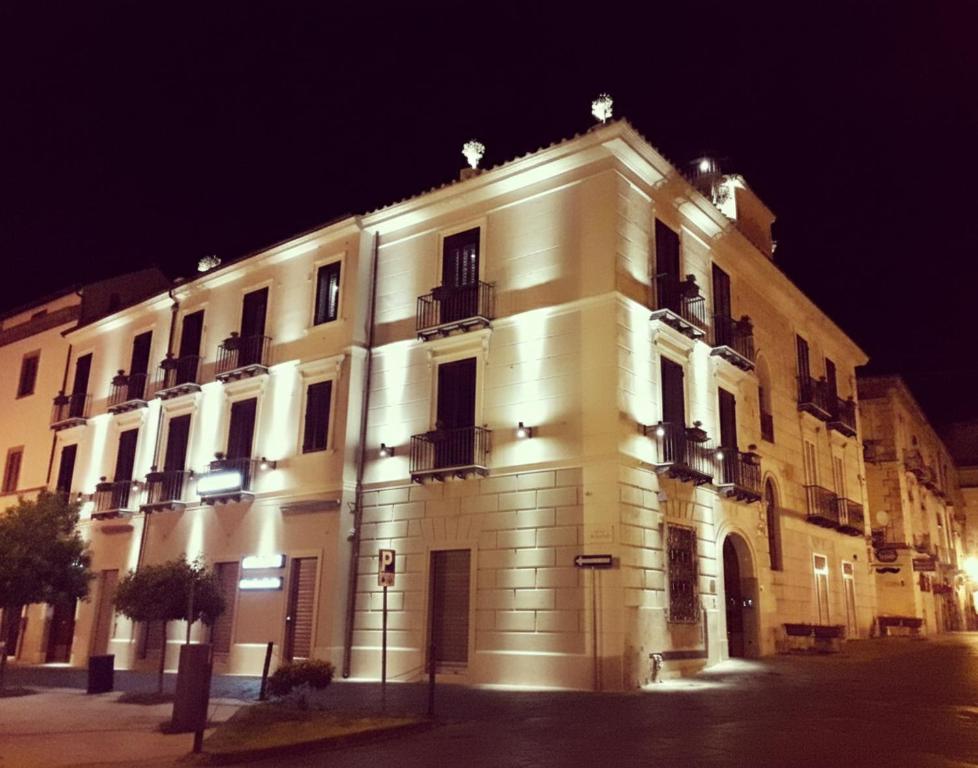 a large white building with lights on it at night at La Locanda del Baffo in Capua