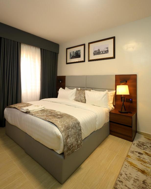 a bedroom with a large bed in a room at Five Clover Hotel, Ilupeju in Lagos