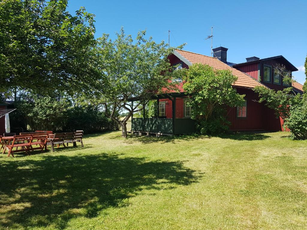 a group of benches in a yard next to a house at Villa Freja in Linköping