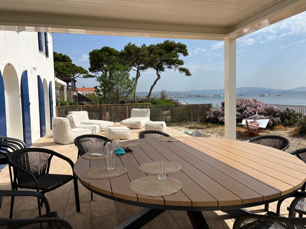 a wooden table and chairs on a patio at Exceptional Waterfront Villa in Hyères