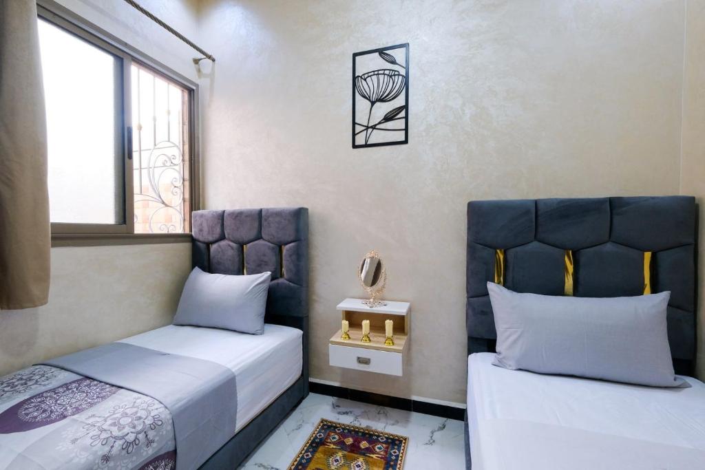 a bedroom with two beds and a basketball hoop at RiadRiad Bollywood-Dream Stay B in Benguerir
